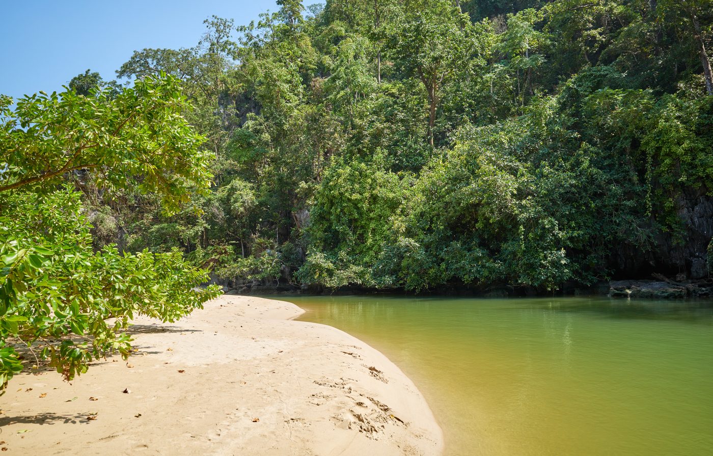Sandy bank and green water at the Underground River estuary, Puerto Princesa