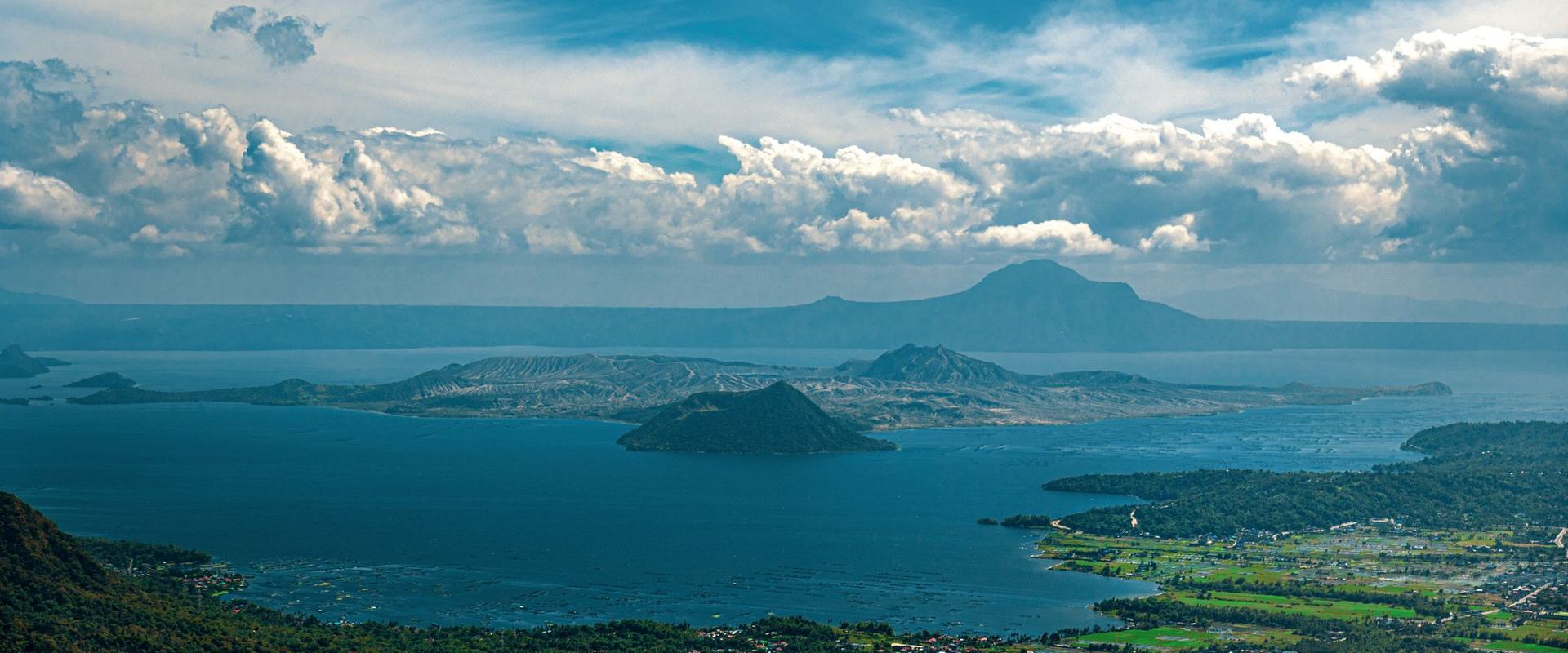 Taal Lake and Volcano seen from Tagaytay under a blue sky